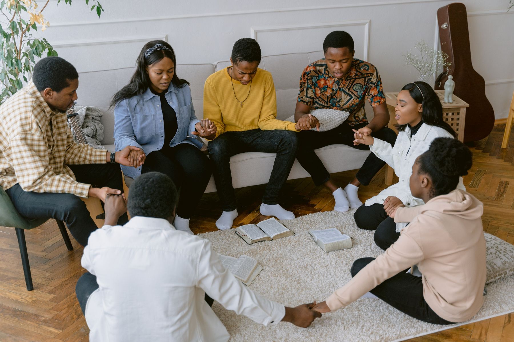 A group holding hands to pray