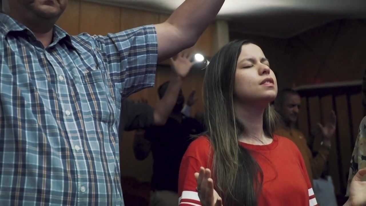 People worshipping with raised hands